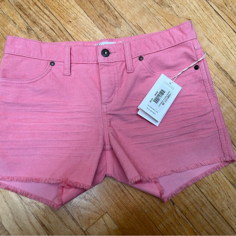 Title Nine Carve Design 4” Dogtown shorts in Grapefruit pink.
